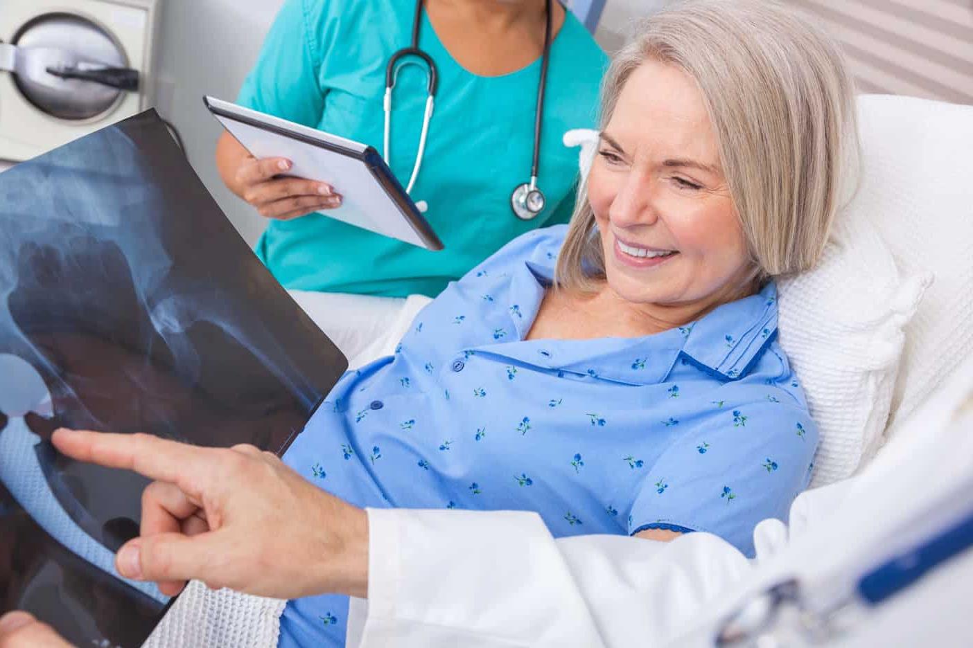 doctor showing woman x-ray